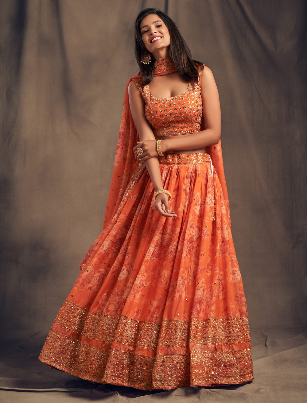 orange designer organza lehenga with elegant floral pattern
